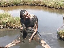 Sexy Girl Playing In The River Mud.  Muddy Fun (Fully Clothed)