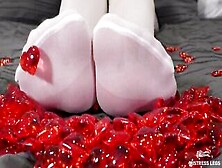 Nylon Toes Play With Red Plastic Hearts On Valentine's Day