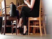 Provocative Shoeplay From Business Woman During A Coffee Break With Her Colleague