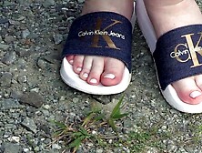 Older FAT WOMAN MILF changing shoes outdoors.