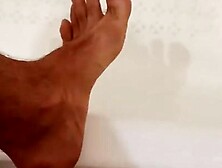 In the bathroom I jerk off and cum on my feet. I dream that you lick the sperm from the leg.