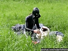 Rubber Whore Full in Dark Latex Catsuit and Mask Plays with herself Outdoor in a Meadow - Part one