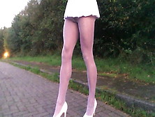 Public Road Walking In White Hose And Pleated Skirt.