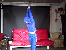 Sexy Sonja Being Tied And Gagged Overhead With Ropes Wearing A Sexy Blue Shiny Nylon Pants And A Jacket (Video)