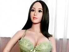 Sexy oriental love doll in green bikini with gigantic boobs ready for doggystyle