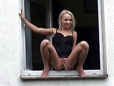 Blonde Babe Squats In The Window To Piss Over The Edge