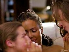 Spencer B,  Kira N and Freya P on a grey coloured sofa in lesbian scene together