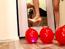 The heels crush the balloons. Crushing heels.