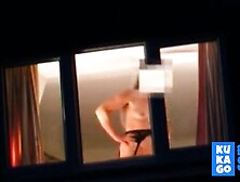 Voyeur watching neighbour at window.