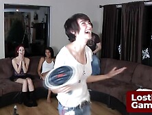 Three friends and one lucky guy playing a strip game in the living room