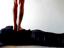 Trampling. Female-dominator Nika walks on the back of her thrall with in nature's garb feet