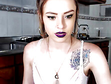 Inked teen in blue jeans oils up her delicious feet and toes in the kitchen