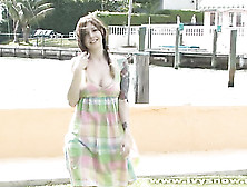 Lovely Young Babe Walks By The Bay Wearing Her Vari Colored Dress Then Sits On The Grass And Shows Her Big Tits Before She Rubs