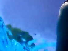 Playgirl tugs on a friend's cock in the pool