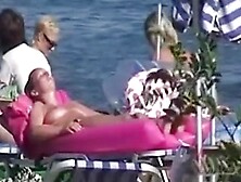 Topless women sunbathing