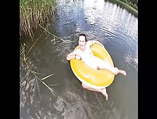 Playing With A Water Donut Naked In The Lake