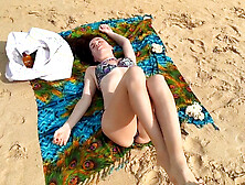 Tanned milf Wildlonelyflower in a micro bikini catches your eye at the beach