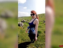 Breasty redhead older shows off her large titties whilst out on a hike