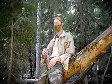 Soldier Sounding His Strung Up Bone In The Wilderness Near A Fallen Tree.