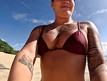 Masculine tattooed girl hits the beach