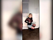 Crossdresser posing in sexy pants, boots, fishnet and corset, sexy red nails