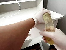 I give a handjob to the dildo with oily hands in medical white gloves