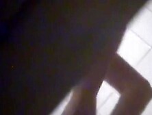 A suntanned girl is wiping her sexy body after shower