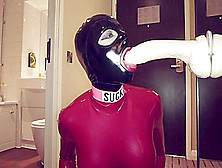 Total Enclosed Skinny Rubberdoll Sucking Spitting On Giant Dildo.