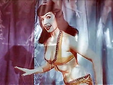 Vintage: Betty Page and Lucy Kraven posing and wrestling