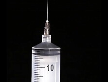 Making of fake breasts: filling of expander silicone breast implant with saline into twice its prescribed size