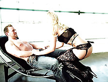 Blonde In Sexy Black Lingerie Crawls Up To Guy On Black Chair In Empty Room