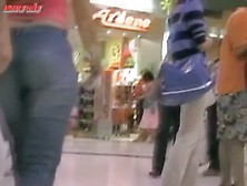 Sexy girl walking around a mall with a cam following