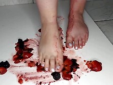 Hispanic ex-wife Steps on dark berries while man watches.