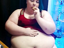Fat woman showsh big belly stuffing in front of the camera