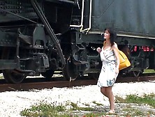 Hot milf fucks herself with dildo next to railway