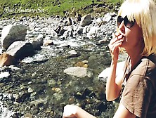 Cute Blonde Milf Smokes Outdoor In Nature Between Mountains