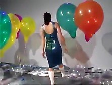 Sexy Girl In Latex Dress Blows To Pop Some Big Balloons