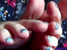 Watch this stunning brunette babe ignore her toes and play with her long,  long feet up close and personal