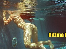 Kittina submerges herself in to the hot pool