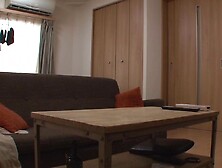 Asian couple is cuddling away from the crowd in a small house