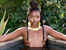 Flexible ebony posing naked in the pool