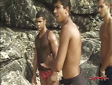 Sensual Tanned Dark Haired Hunk Takes Two Dicks On The Sand!