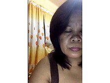 Filipino Grandmother showing her delites on camera