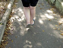 Big Beautiful Woman In Flip Flops Walks Along The Sidewalk Whilst A Voyeur Peeps On Her Feet Public Foot Fetish