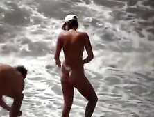 Naturists Enjoying The Wavy Sea