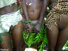 2 African tribe girl having fun with the village chief in the middle of the forrest